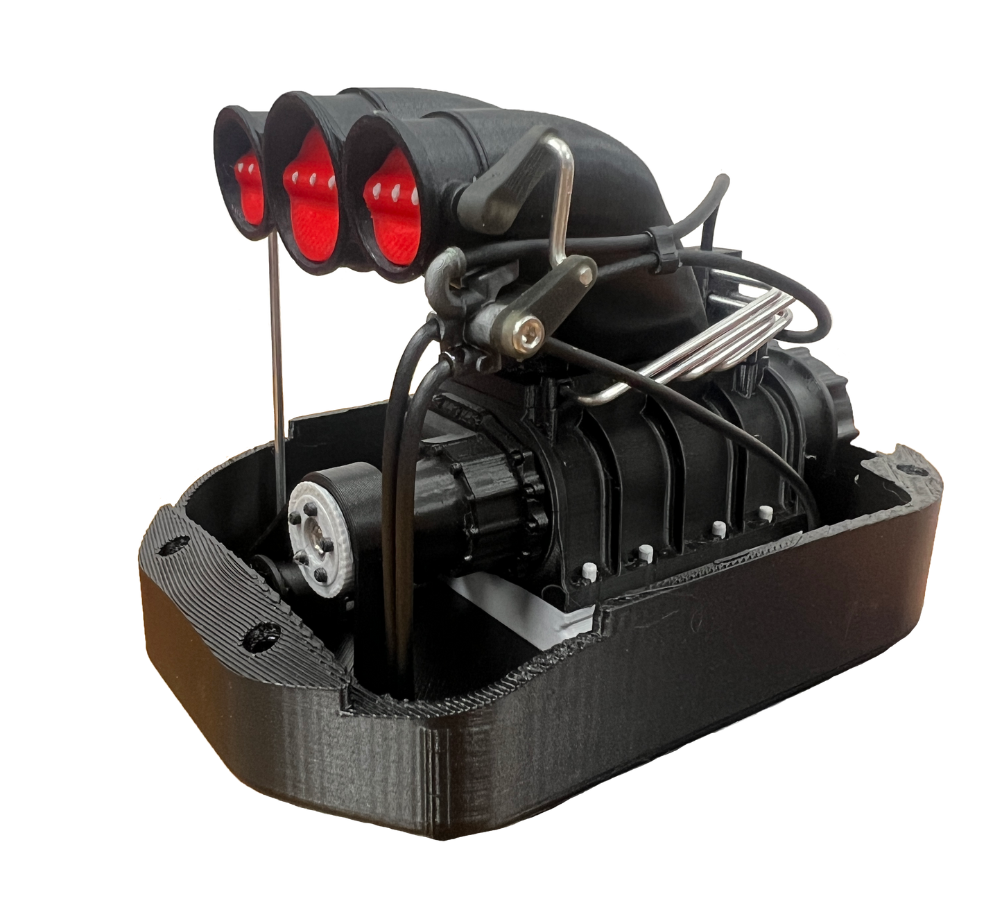 Black mechanical model with red lights on a white background
