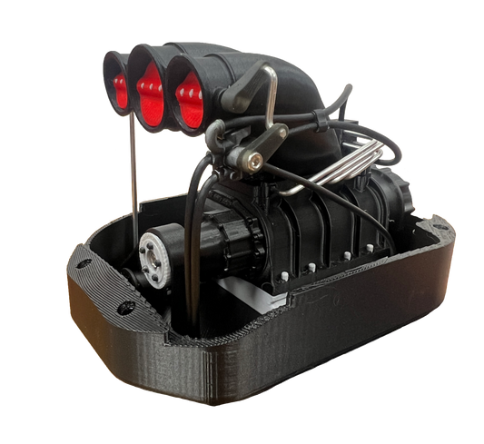Black mechanical model with red lights on a white background